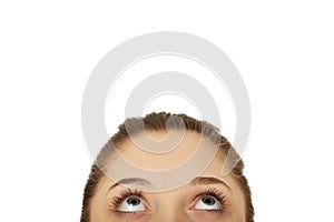 Young woman's eyes looking up.