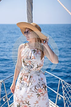 Young woman sailing, young adult lady enjoying summer travel, close-up portrait of female face, summer cruise holidays