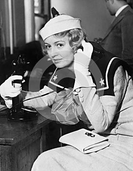 Young woman in a sailors uniform on the telephone