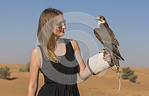 Young woman with saker falcon