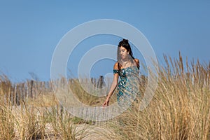 YOUNG WOMAN ON THE SAND OF THE BEACH