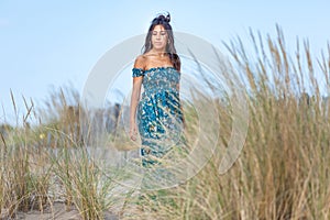 YOUNG WOMAN ON THE SAND OF THE BEACH