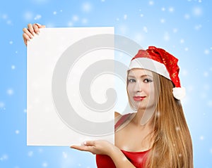Young woman in santa claus hat with christmas card