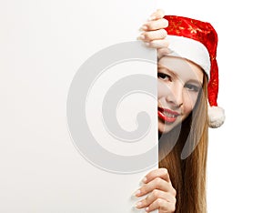 Young woman in santa claus hat with christmas card