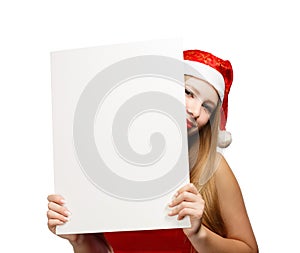 Young woman in santa claus hat with christmas card