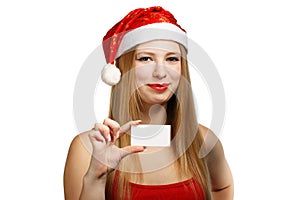 Young woman in santa claus hat with christmas card