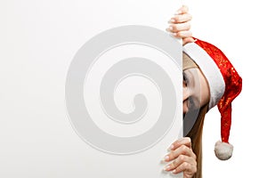 Young woman in santa claus hat with christmas card