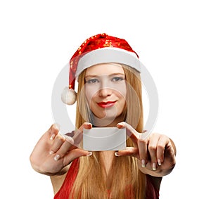 Young woman in santa claus hat with christmas greeting card