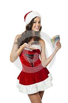 Young woman in Santa costume pointing at money.