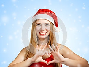 Young woman in santa hat with heart shape