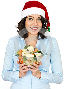 Young Woman in Santa Hat Holding Bowl of Cooked Mixed Vegetables