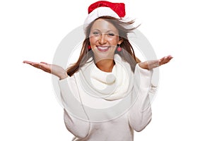 Young woman in a Santa hat holding out her hands