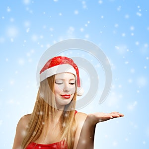 Young woman in santa hat with open hand