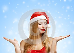 Young woman in santa hat with open hands