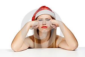 Young woman in santa hat with scowl look