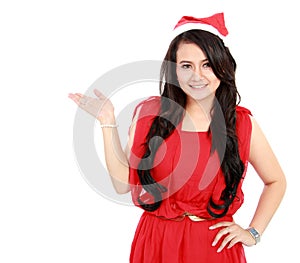 Young woman with santa hat showing blank space
