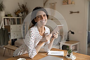 Young woman satisfied user of pad enjoy good device work