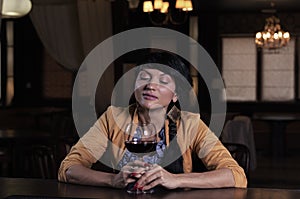 Young woman savouring a glass of red wine