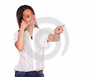 Young woman saying call me pointing to her left