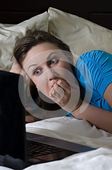 Young woman scared while watching movie