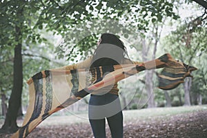 Young woman with scarf at park. On the move.