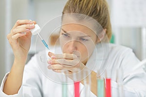 young woman in scientific lab with pipette