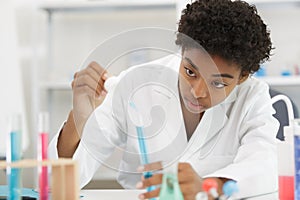 young woman in scientific lab with test tubes