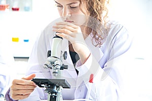 Young woman scientist, researcher, technician, or student conducted research or experiment in laboratory photo