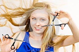 Young woman with scissors for haircutting