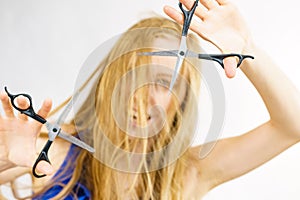 Young woman with scissors for haircutting