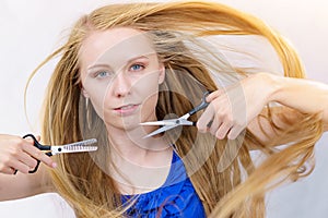 Young woman with scissors for haircutting