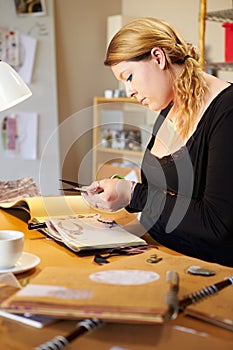 Young Woman Scrapbooking At Home