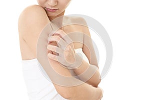 Woman scratching her itchy arm with allergy rash photo