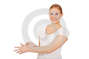 Young woman is scratching herself on wirst