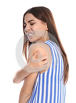 Young woman scratching shoulder on white background