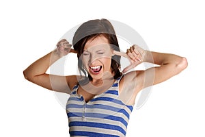 Young woman screaming with clogged ears.
