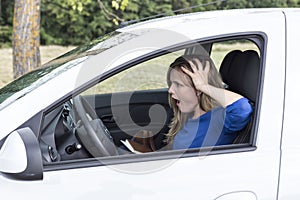 Young woman screaming while driving the ca