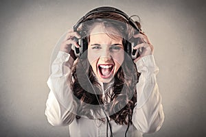 Young woman screaming and listening to the music