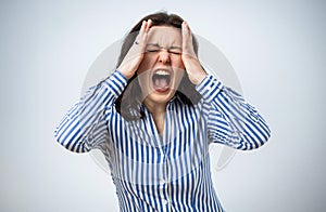 Young woman screaming, looking very negative