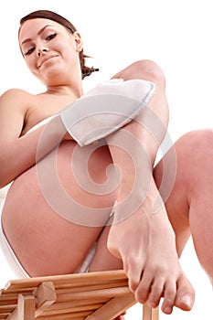 Young woman scrubbing body. photo