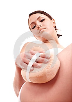 Young woman scrubbing body. photo