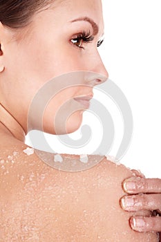 Young woman scrubbing body. photo