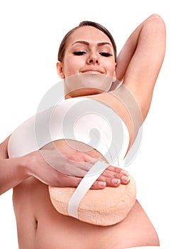 Young woman scrubbing body. photo