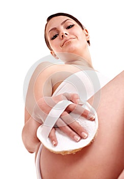 Young woman scrubbing body.
