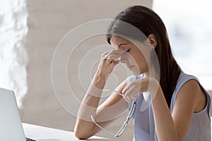 Young woman taking off glasses reduces painful feelings eye strain photo