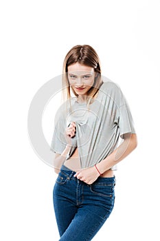 Young woman seductively looking at camera and lifting shirt