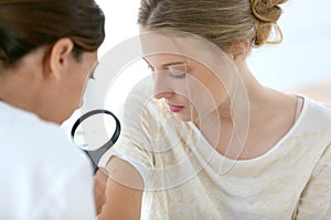 Young woman seeing dermathologist photo