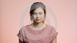 Young woman seeing the result of the pregnancy test, girl crying and asking God why, female emotions on pink studio background, fr