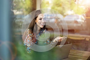 Woman seen through cafe window