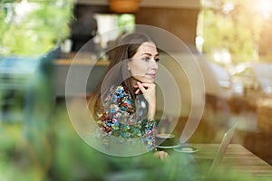 Woman seen through cafe window